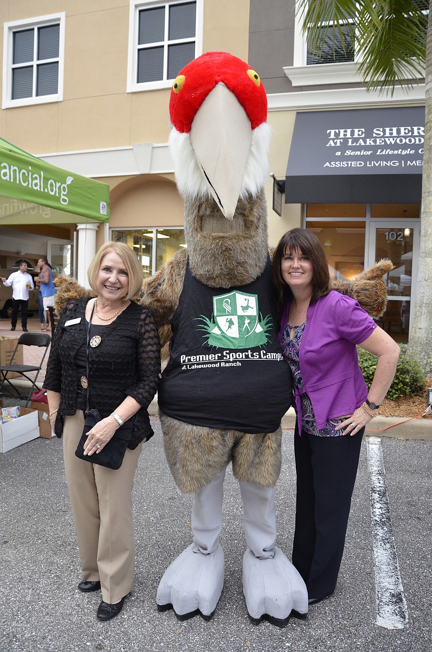 Debbie Rausch and Jen Cassidy hang out with Cranky the sandhill crane at the Lakewood Ranch Information Center booth.