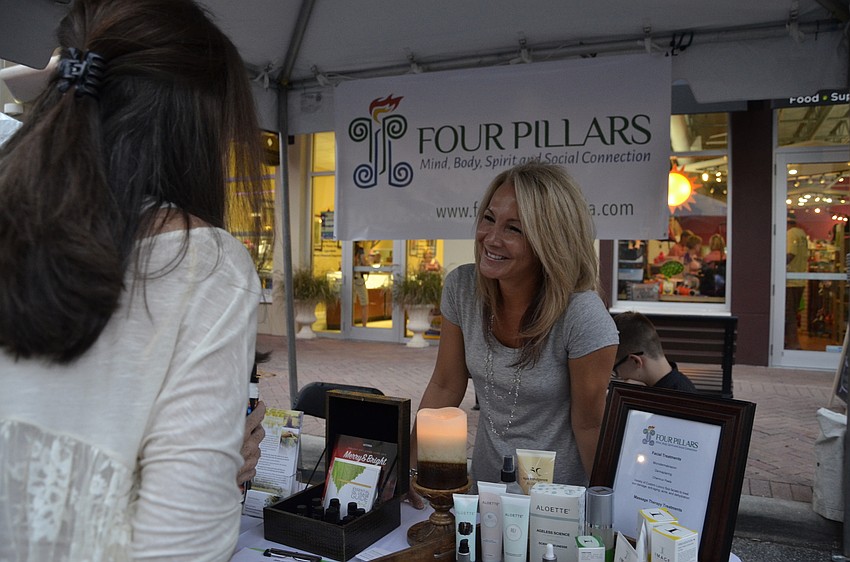 Heather Perry, owner of Canine Ranch Country Club, talks with Nancy Brown, a spa specialist at Four Pillars, which is opening in November.