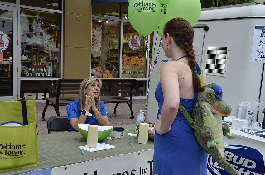 Kitt Kearney talks with Christena Pellett, a LECOM student, at the Homes by Town booth.