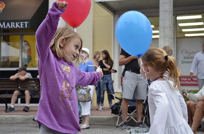 Layla and Emeline Corenman  dance to live music at the block party.