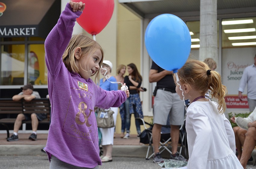 Layla and Emeline Corenman  dance to live music at the block party.