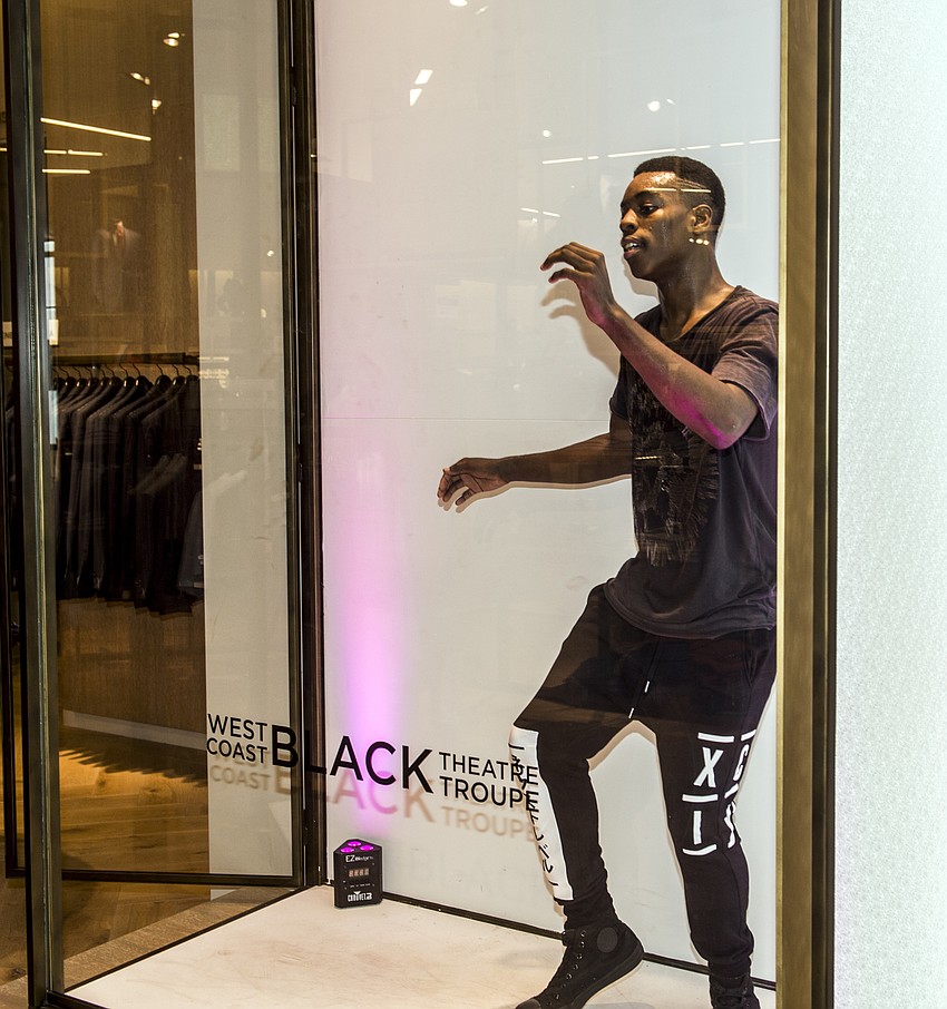 WBTT students Derrick (pictured here) and Josh danced for guests in glass vitrines