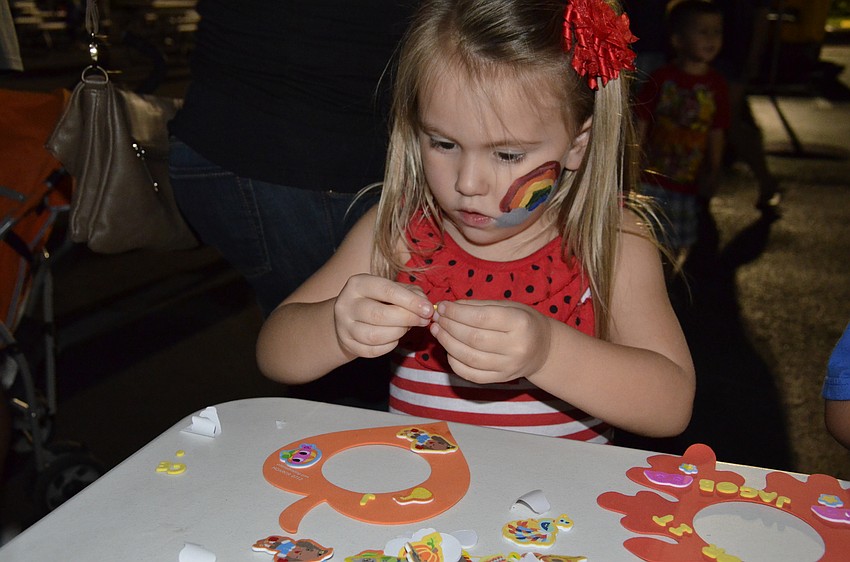 Jocelyn Gomez decorates a pumpkin.