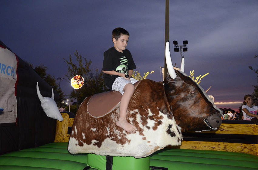 Jon-Ryan Pouso rides the mechanical bull.