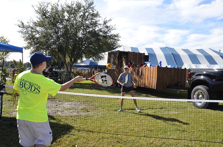 Justin Bear and Kathy Rosenberg play a little tennis at the Buddy Up Tennis booth.