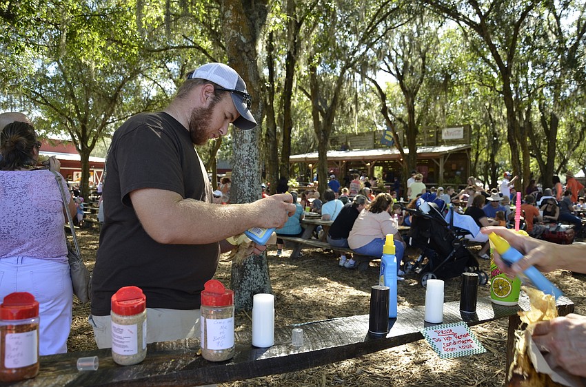 Dylan Beetle of Bradenton doctors up a corn on the cob with butter and savory rub.