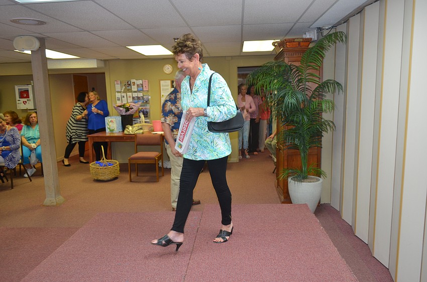 Carol Peschel models with a copy of the Longboat Observer