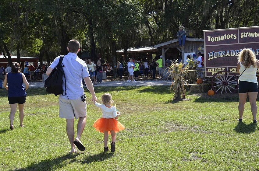 Jack Kelley walks with his daughter, Jensie. The family traveled from Clearwater to attend the festival.