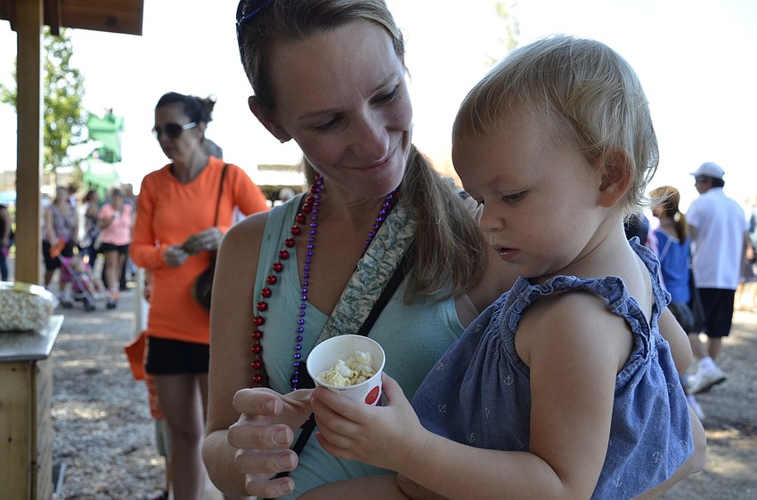 Meredith Delcamp from St. Pete lets Emma try some kettle corn.