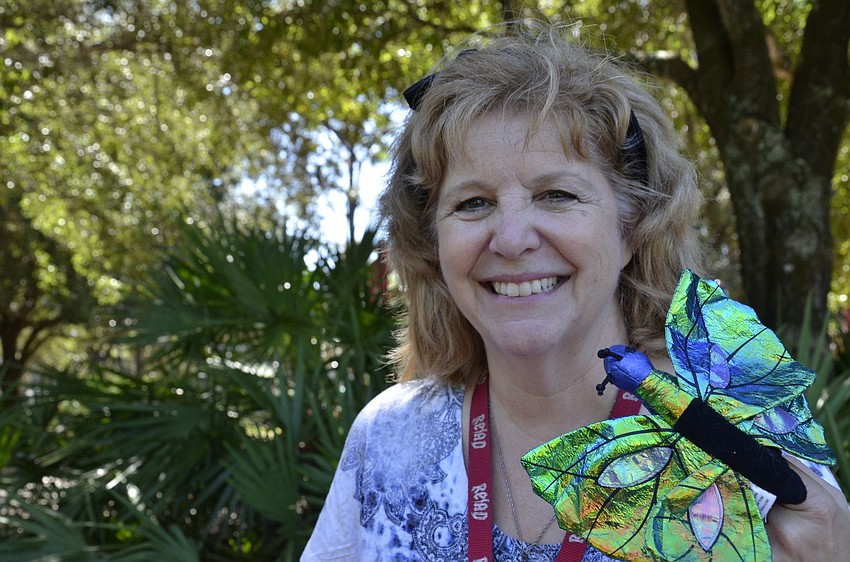 Chris Culp with the Braden River Branch Library shows off her butterfly puppet.