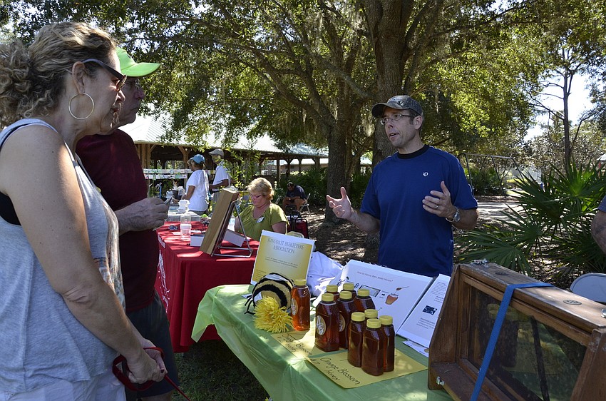 T.J. and Florey Miller chat with Kent Bontrager with the Suncoast Beekeepers Association about backyard beekeeping.