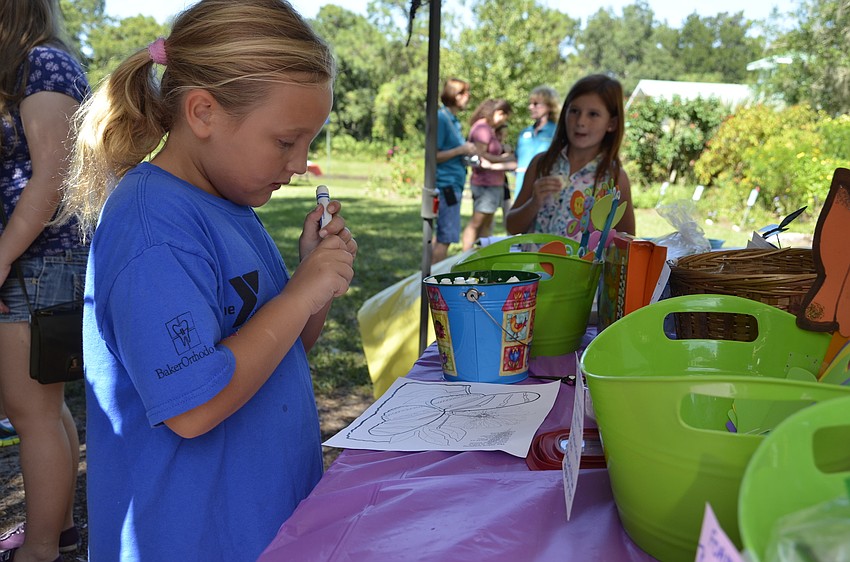 Valerie Stolte, a Gilbert W. McNeal Elementary student, colors in a butterfly.