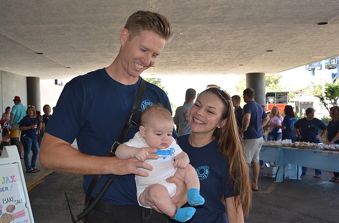 Donald and Kara Bunch hold their 5-month-old baby Jaxson during a fundraiser on Saturday at the Ellenton Ice and Sports Complex to help pay medical costs for the baby's illness.