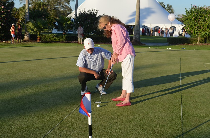 Commissioner Lynn Larson participates in a putt-off to raise money for the town’s 60th anniversary party.