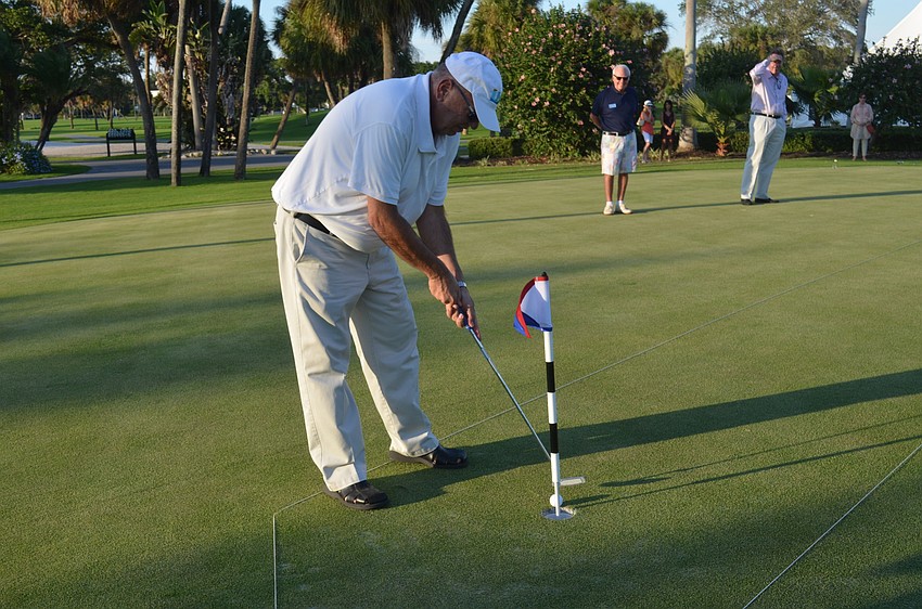 Public Works Director Juan Florensa participates in a putt-off to raise money for the town’s 60th anniversary party.