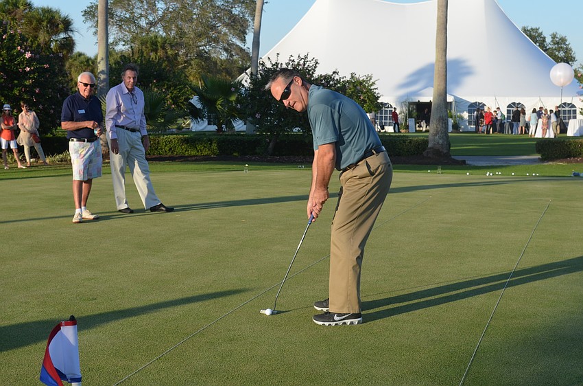 Fire Chief Paul Dezzi participates in a putt-off to raise money for the town’s 60th anniversary party.