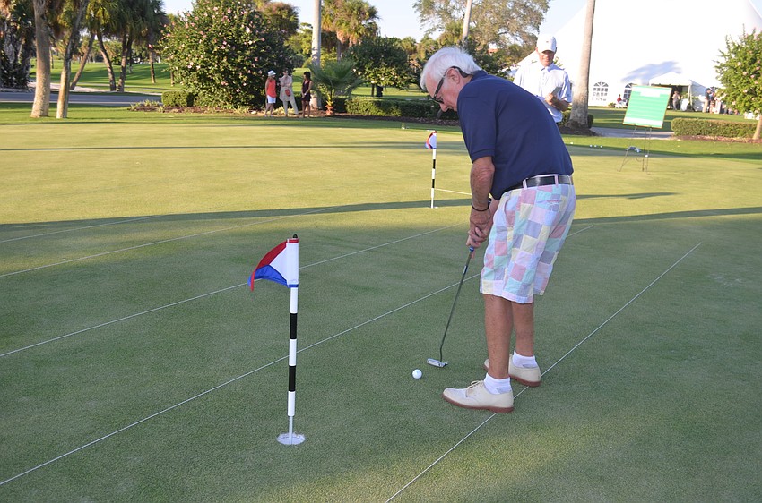 Commissioner Jack Daly participates in a putt-off to raise money for the town’s 60th anniversary party.