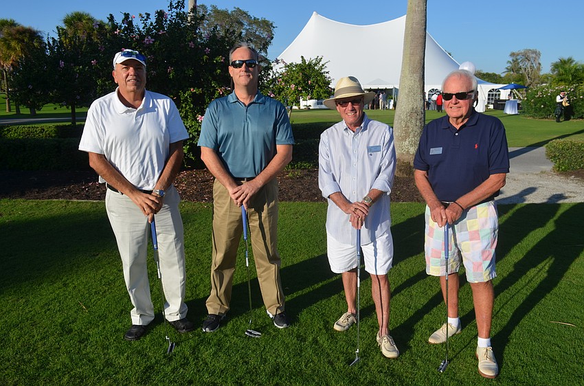 Public Works Director Juan Florensa, Fire Chief Paul Dezzi, Mayor Jack Duncan and Commissioner Jack Daly participate in a putt-off to raise money for the town’s 60th anniversary party.