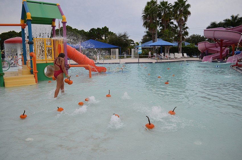 Lifeguards assisted in adding pumpkins to the Water Park pools for children to rush in and grab.
