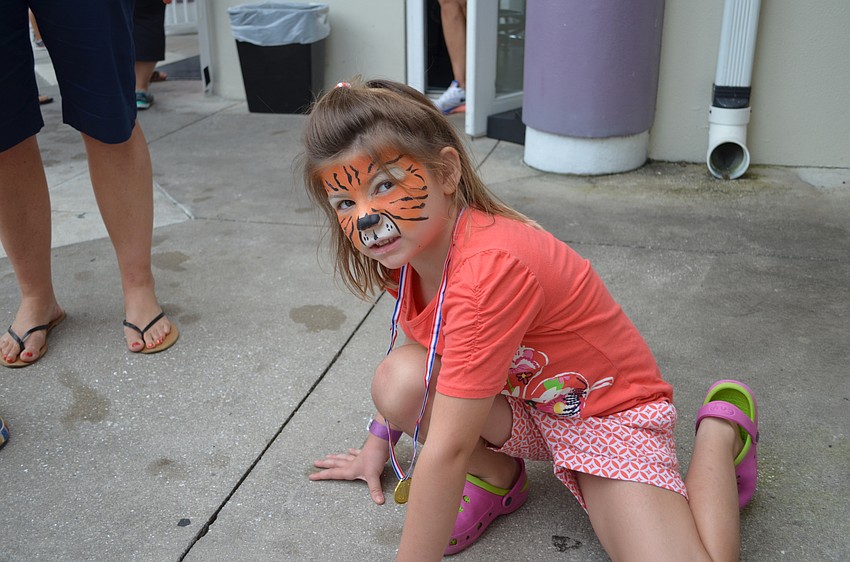 Caiden Grace Sedlak gets into character with her face painted as a tiger.