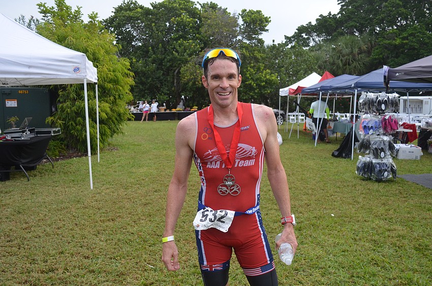 Anthony Aseere wins the sprint triathlon in 52:31.
