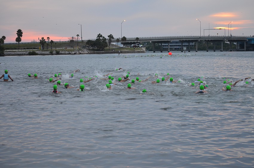 Participants begin the triathlon with the swimming portion.