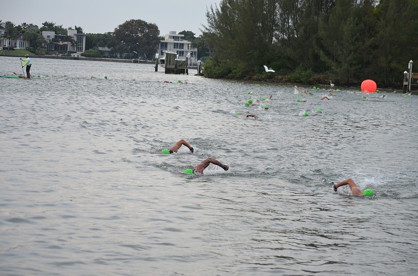 Participants begin the triathlon with the swimming portion.