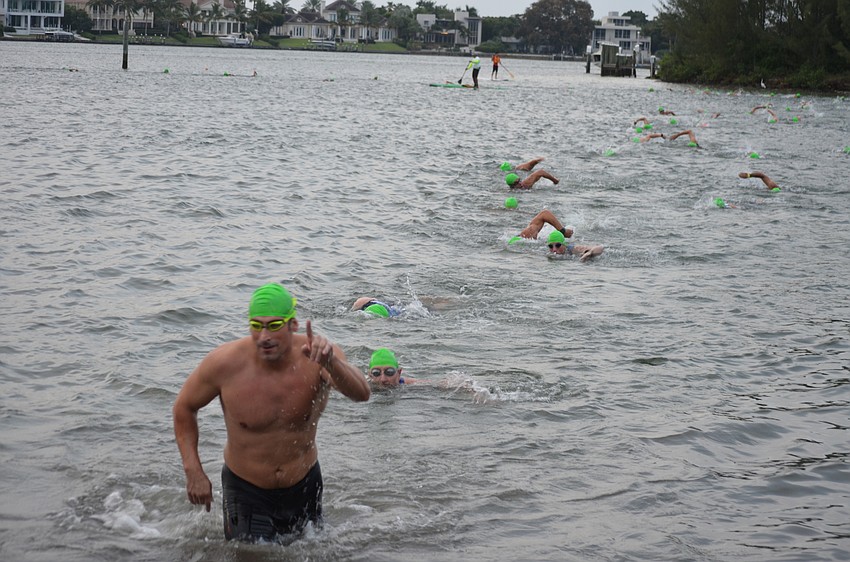 Male swimmers end their first of two laps.
