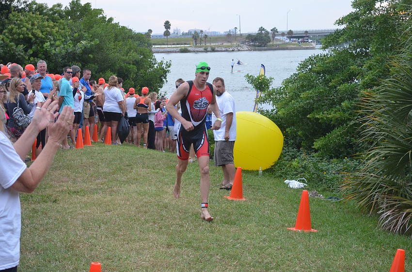 Participants end the swimming portion and head to the bikes.