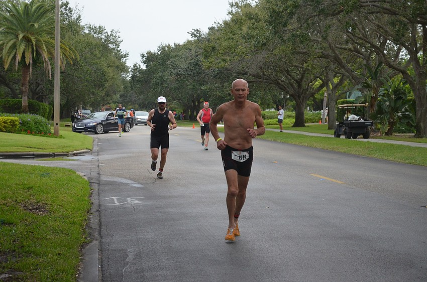 Participants begin the running portion of the triathlon.