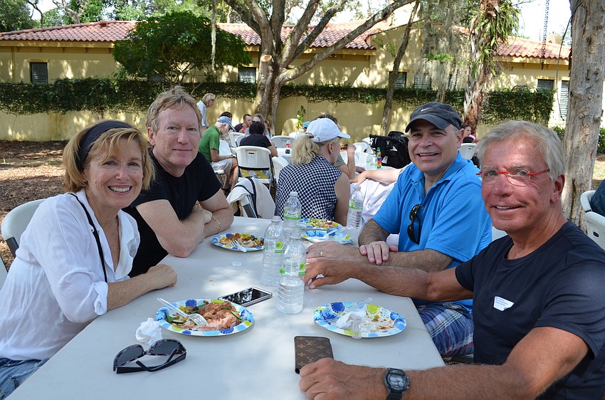 Neighbors Stephanie Wingate, Kent Hofmeister, Paul Cardi and John McCue enjoy lunch together.