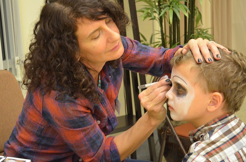 Owen Lockaby has a skeleton painted on his face by Lisa Lucas.