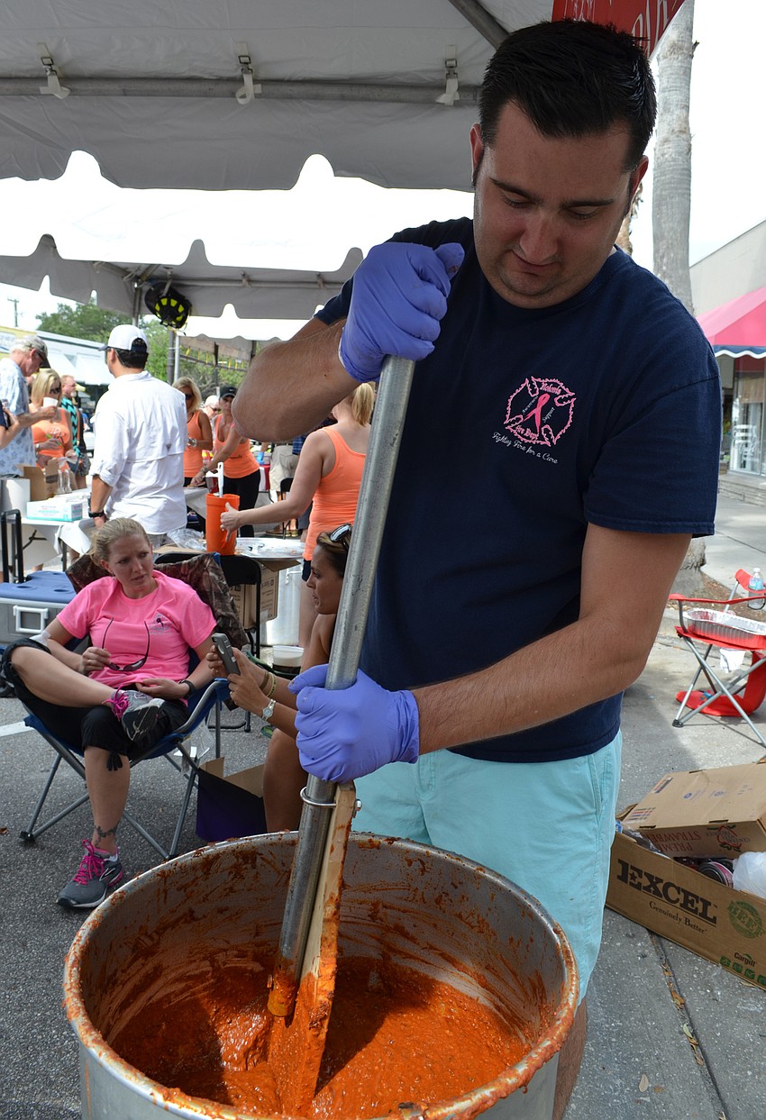 Dan O'Connor stirs a batch of chili for the Englewood Fire Department.