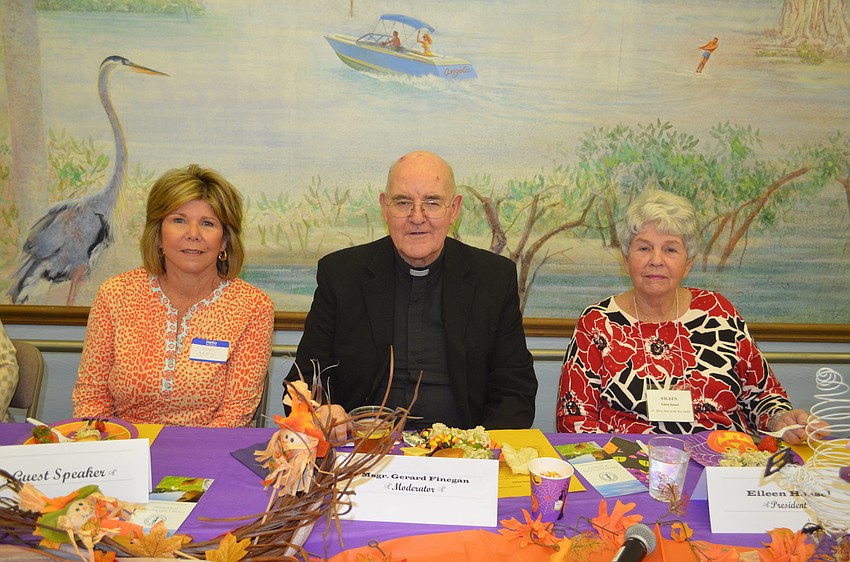 Janet DeAngelo, of the Christ Child Society of Sarasota, Msgr. Gerry Finegan and Women’s Guild President Eileen Hassel