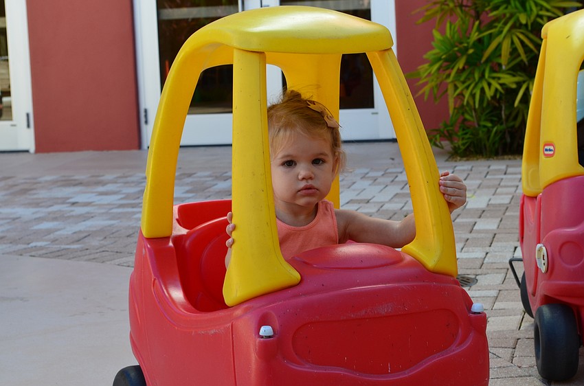Estella Strouth and her classmates in the 18-month-old class steered Little Tyke play cars.