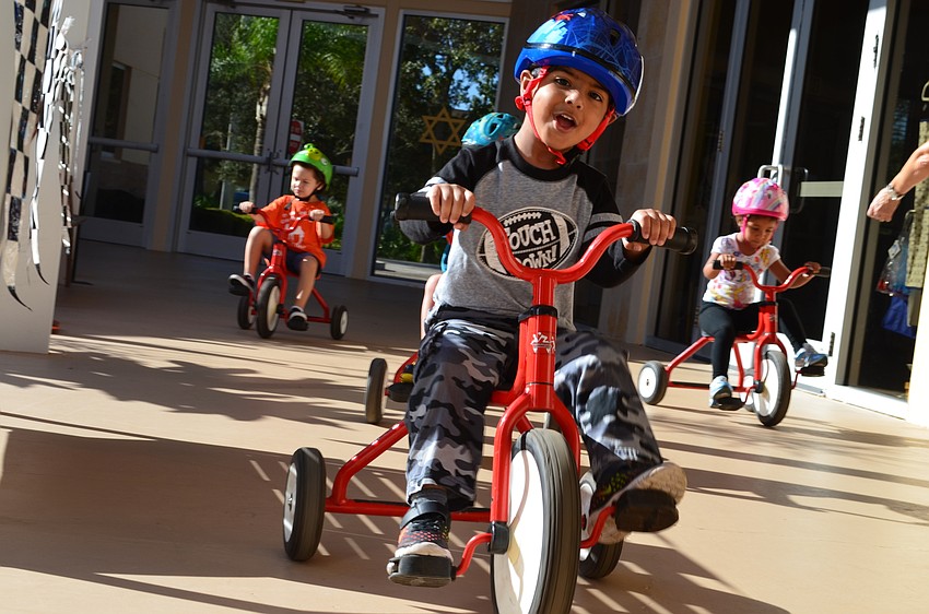 Gurbaj Singh leads the pack of students riding tricycles for The Gan Trike-a-thon Wednesday morning.