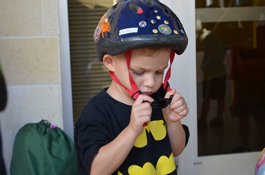 Sam Zoller makes sure that his helmet is on securely.