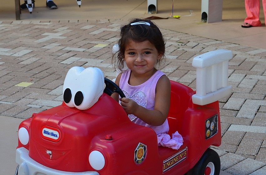 Zoey Moyal steers a play firetruck.
