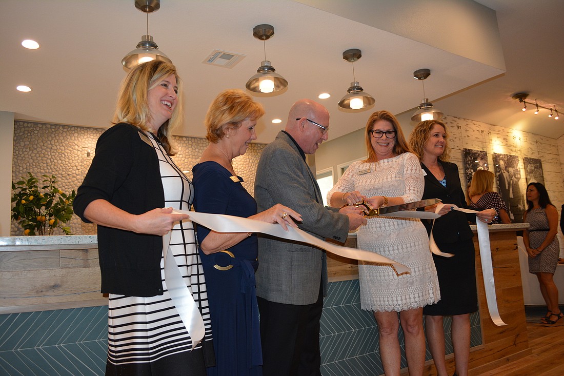 The ribbon is cut for the reopening of the Lakewood Ranch Information Center on University. Enjoying the moment were Heather Kasten, Vanessa Baugh, Jimmy Stewart, Angie Kaleskas, and Jahna Leinhauser.