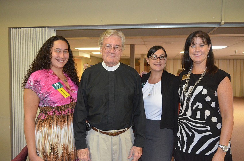 Aurora Kane, of Century 21, the Rev. Vincent Carroll, Jessica Southwick, of AAA Payroll Services and Chamber member Tammy Halsted