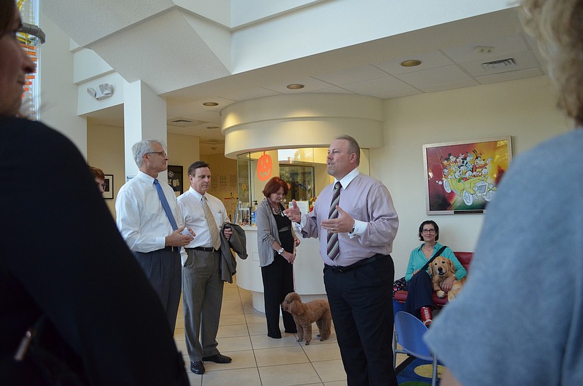 Child Protection Center Executive Director Doug Staley welcomes guests to the building and introduces them to the Pillar of Hope in the lobby Thursday evening .