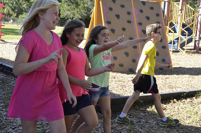 Ryleigh Young, Elizabeth Wharry and Avery Powell sing along to some music during their lap.