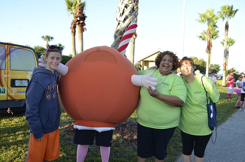 Mathew Stalowski, Andrea Brown and Isabel Stalowski with Tropicana pose with the Orange Man (played by Tim Sink).