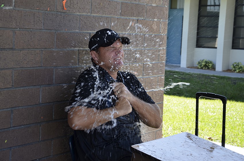 Third-grade teacher Charles Rogalla gets blasted with a water balloon.