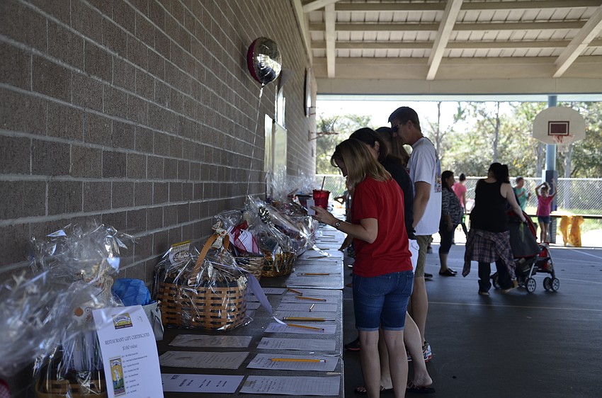 Parents and family signed up for the silent auction baskets.