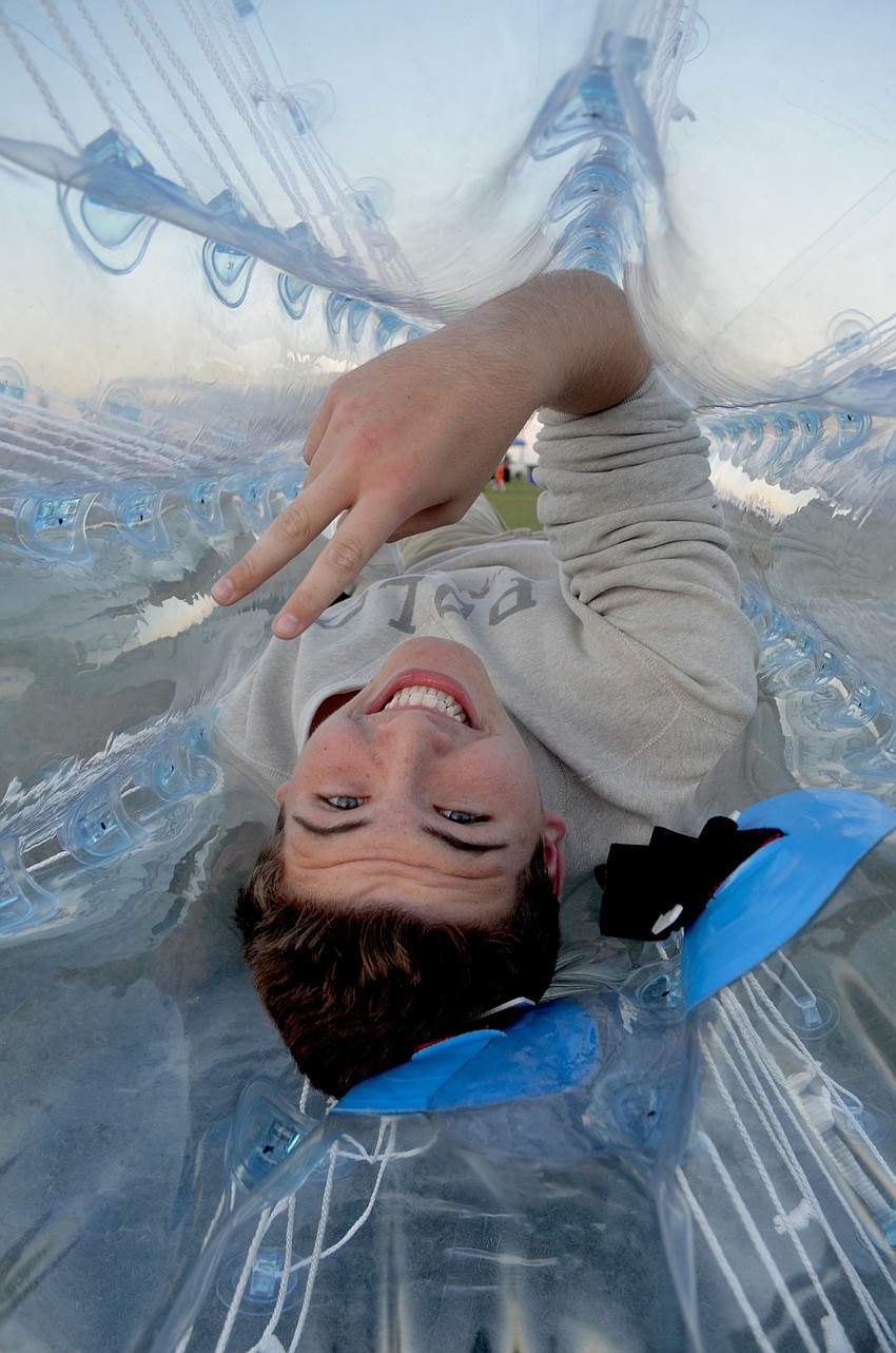 Houston Sharp, of Lakewood Ranch, tests out a plastic ball toy in which his friends pushed him around.