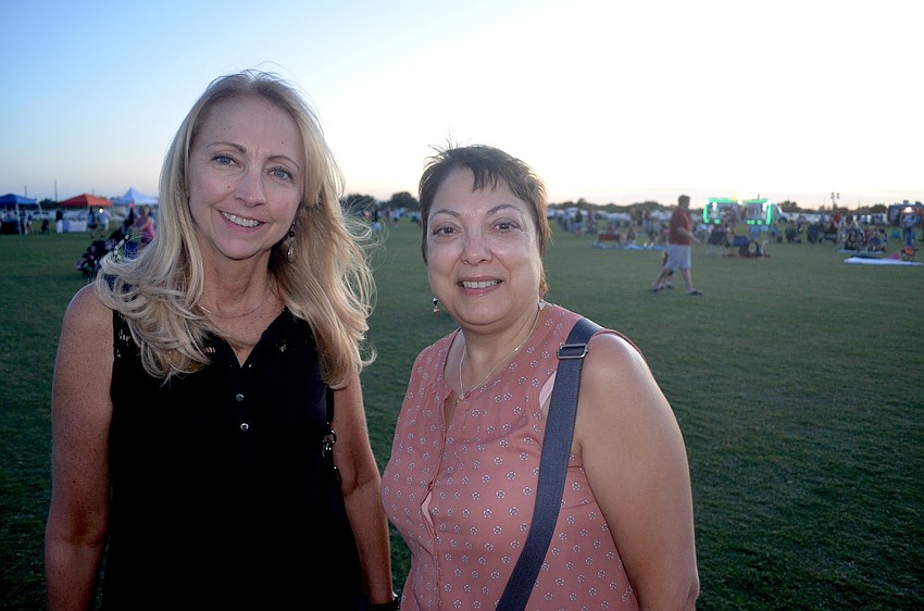 Ranch residents Susan Gaylo and Teresa Kravitz search for a place on the lawn to watch the band.