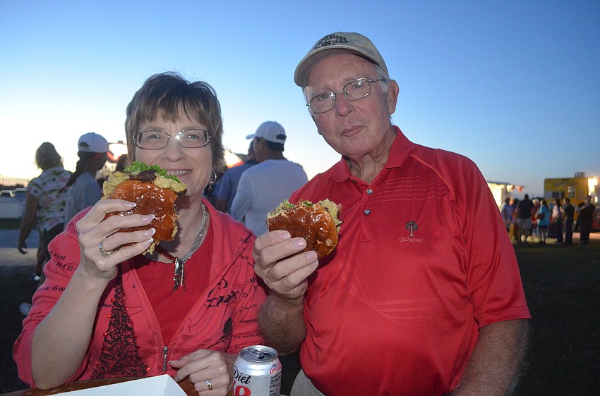 Barbara and Glenn Welcher, of Country Club East, test out of the seafood options at the event.