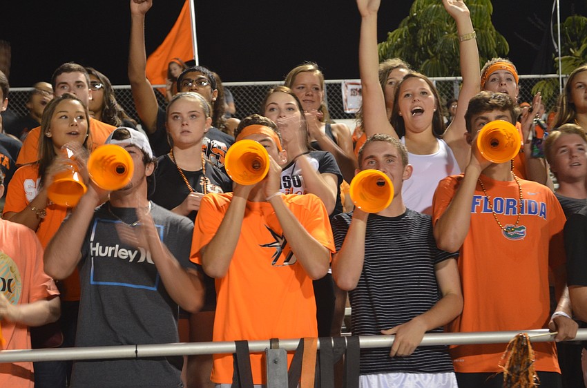Joey Arnold, Phil Shore, Parker Spence and Reid Guengerich make sure their cheers are heard from the student section.