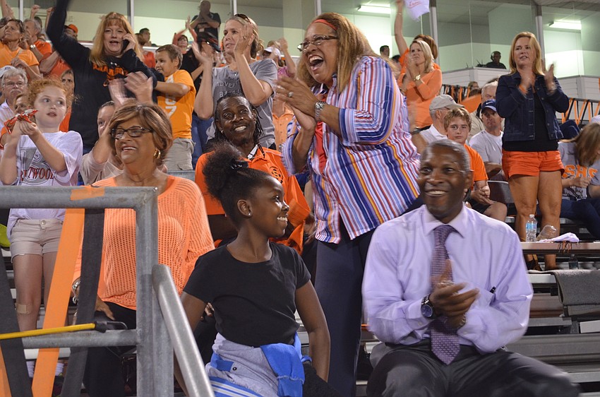 Angela DuBose jumps to her feet to cheer on her grandson Deric DuBose who scored a touchdown. With her are June Robinson, Leah and Keith DuBose.